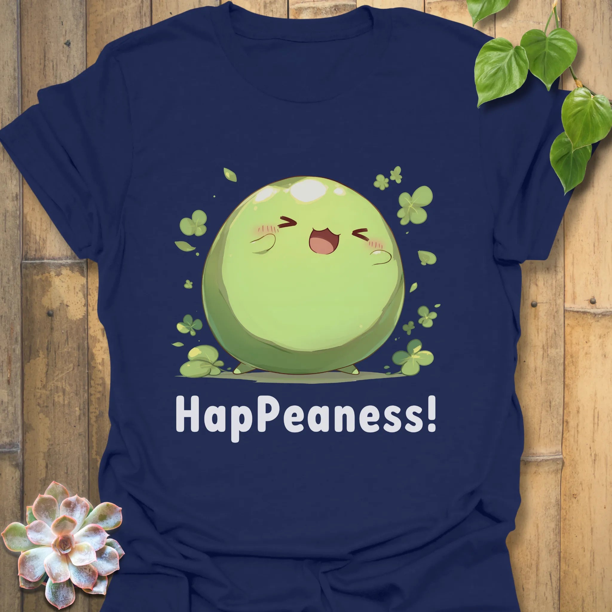 Navy blue t-shirt displaying a cheerful green pea character and the word “HapPeaness!”