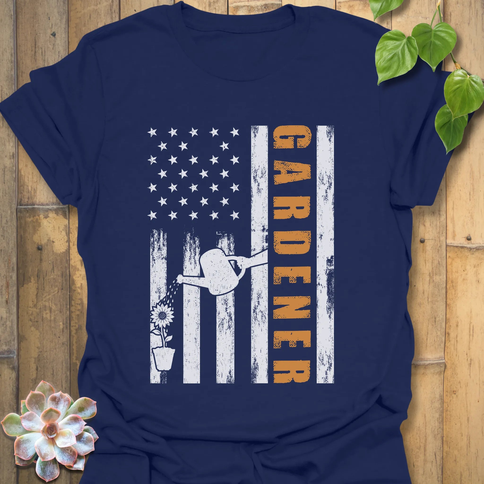 Navy gardener gift shirt featuring the design Gardener with a vertical word, American flag, plant, and watering sprinkler print for gardening enthusiasts