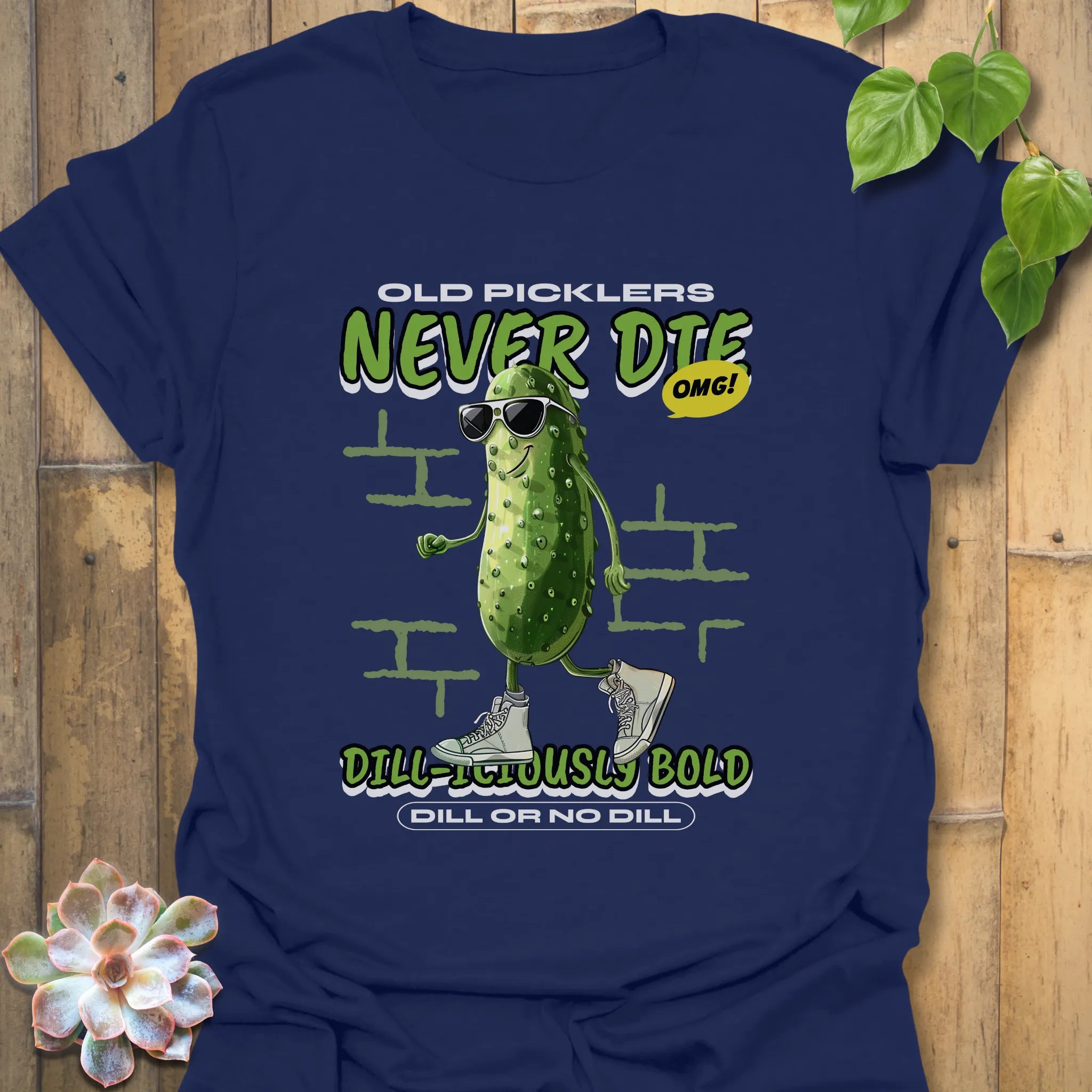 Navy t-shirt displaying the words “Old Pickles Never Die Dill-Iliously Bold” with a cucumber figure wearing dark glasses