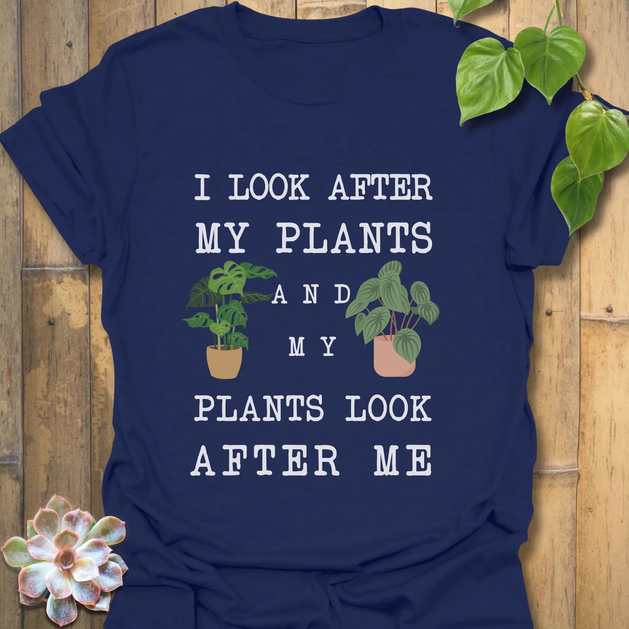 Navy t-shirt featuring the design “I look after My Plants and my plants look after me” botanical graphic tee.