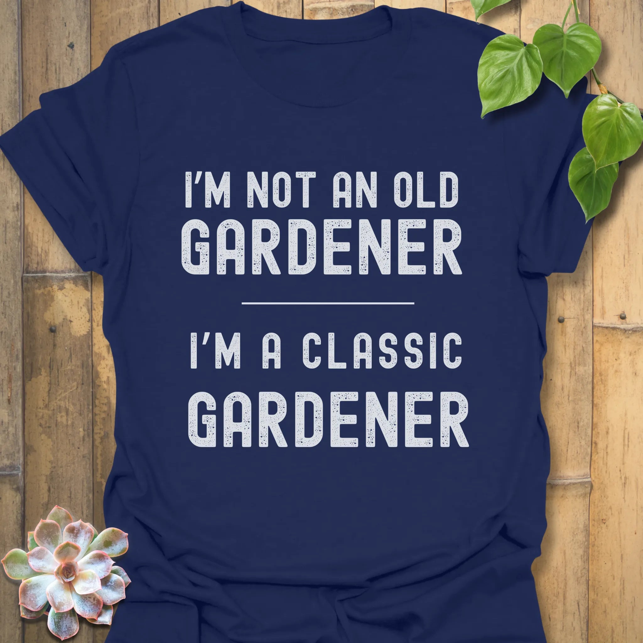 Navy t-shirt featuring the design “I’m not an older gardener, I’m a classic gardener” garden humour graphic tee.
