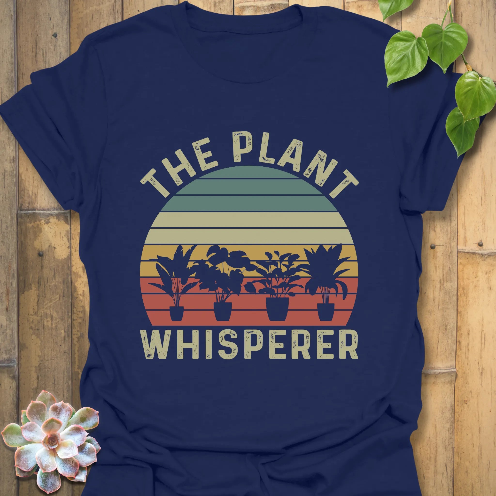 Navy t-shirt featuring the design The Plant Whisperer with a plant in a pot, a perfect casual gardening t-shirt for nature lovers.