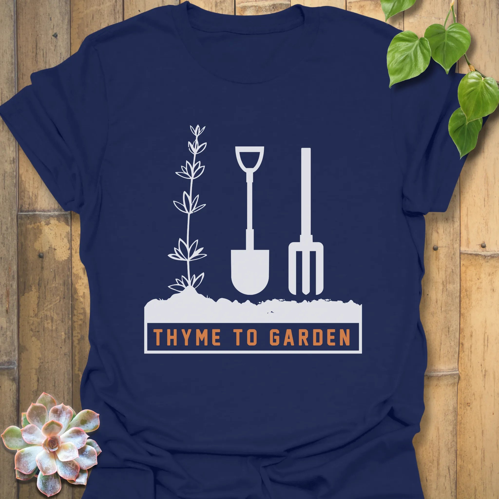 Navy t-shirt featuring the design "Thyme To Garden" with garden tool illustrations, a comfortable gardening shirt for plant enthusiasts.