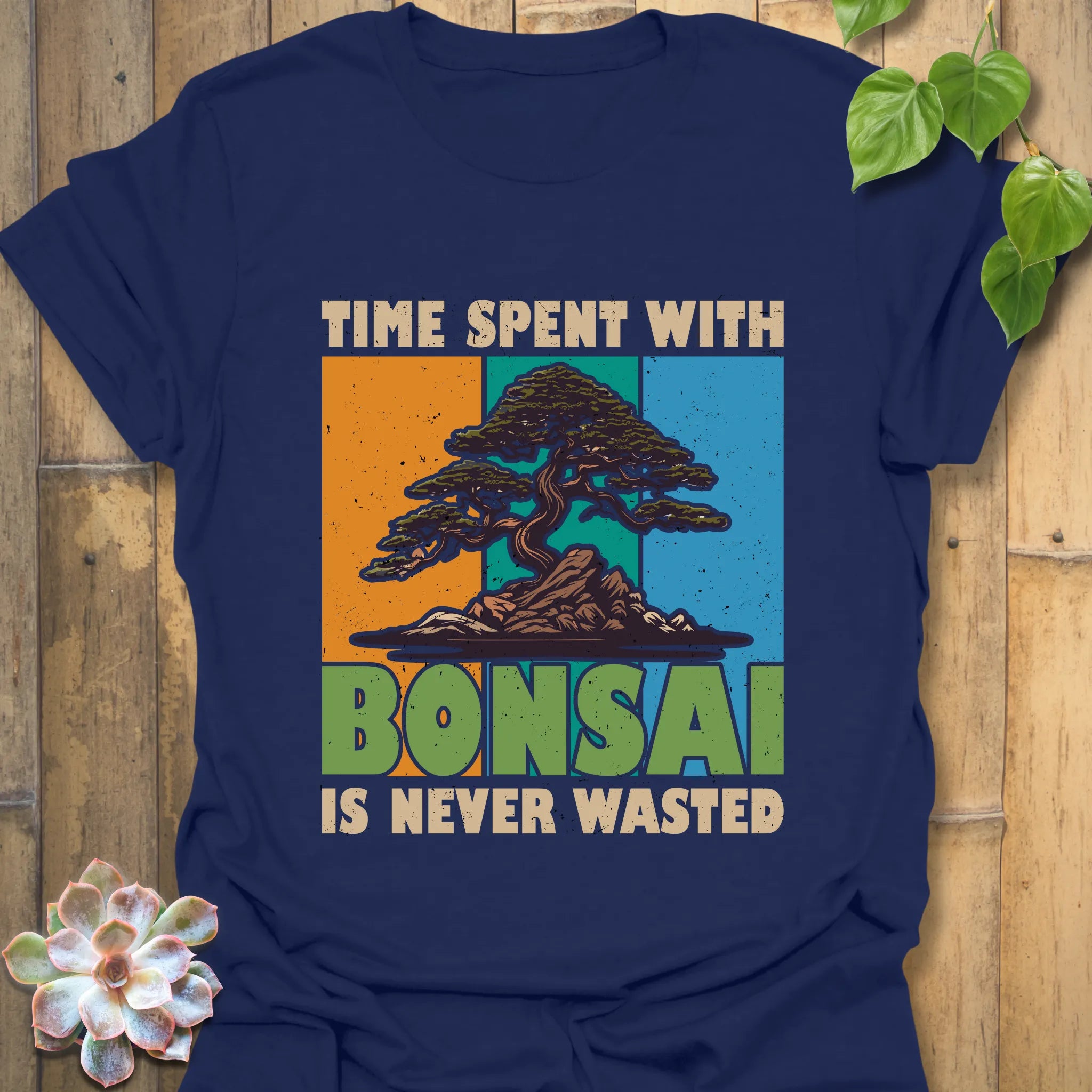 Navy t-shirt featuring the design “Time spent with bonsai is never wasted” with a bonsai plant print, classic casual wear nature lovers.