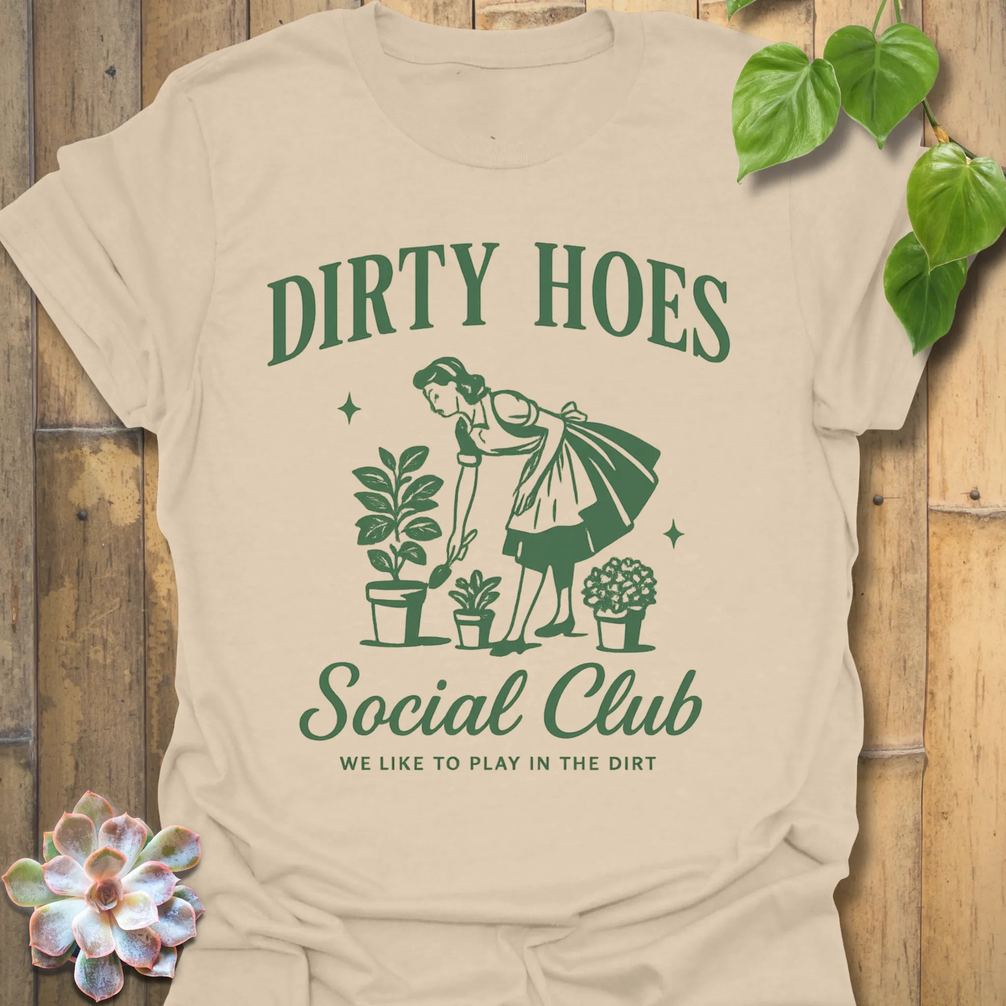 Sand t-shirt featuring the design Dirty Hoes printed in bold letters, gardening graphic tee.