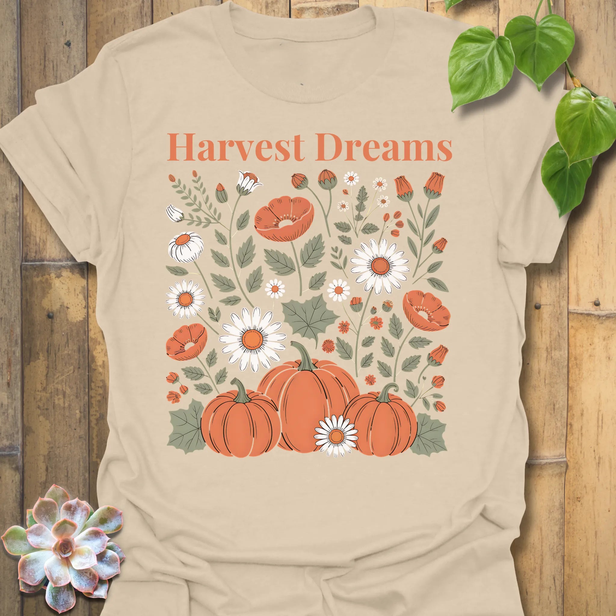 Sand t-shirt featuring the design Harvest Dreams printed in bold orange letters, cosy harvest tee.