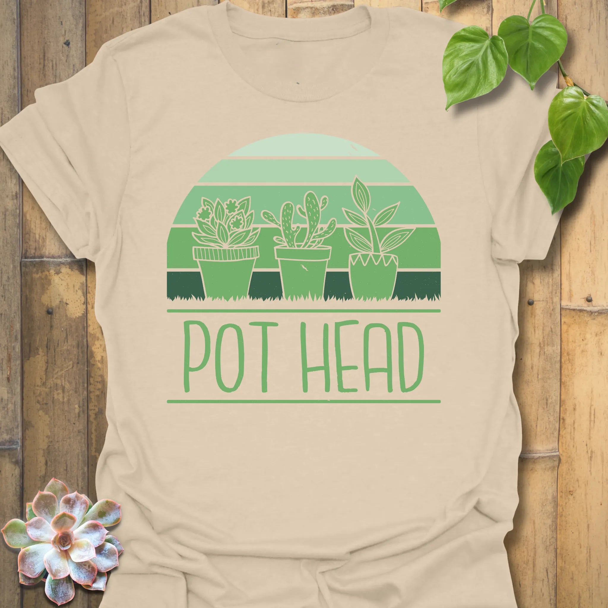 Sand t-shirt featuring the design Pot Head printed in bold green letters, garden lover shirt.