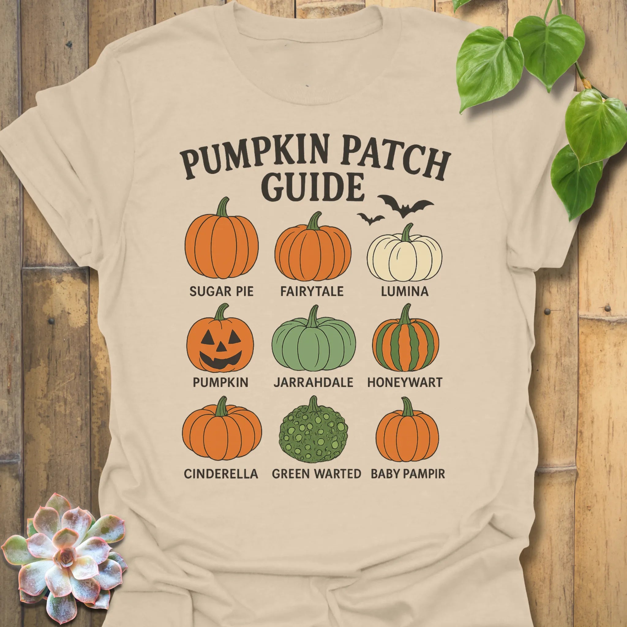 Sand t-shirt featuring the design Pumpkin Patch Guide printed in black letters, Halloween pumpkin tee.