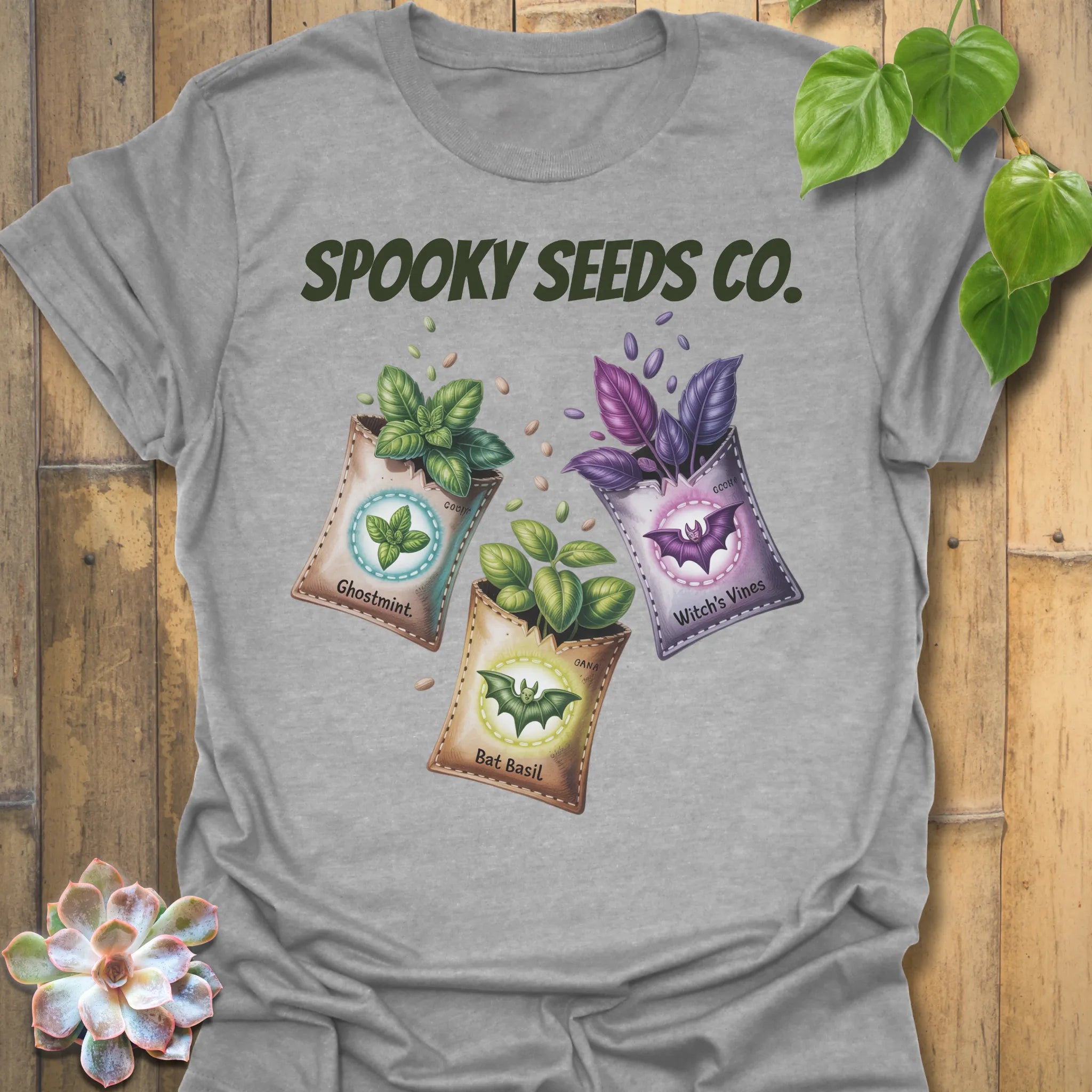 Sport Grey t-shirt featuring the design Spooky Seeds Co. printed in bold letters, spooky plant lover shirt.
