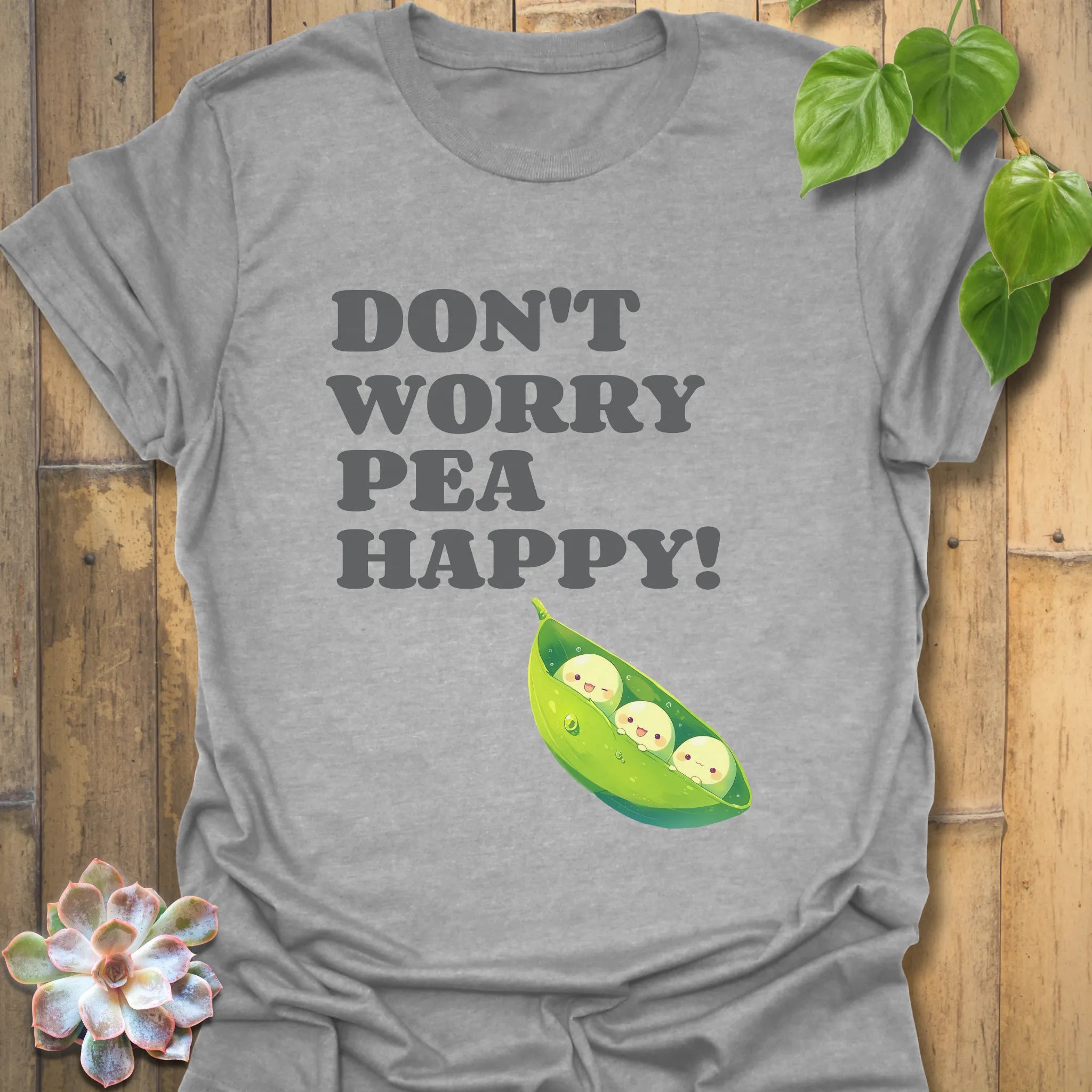 Sport grey t-shirt featuring the design “Don’t Worry Pea Happy” in bold white letters with three smiling peas in a pod illustration