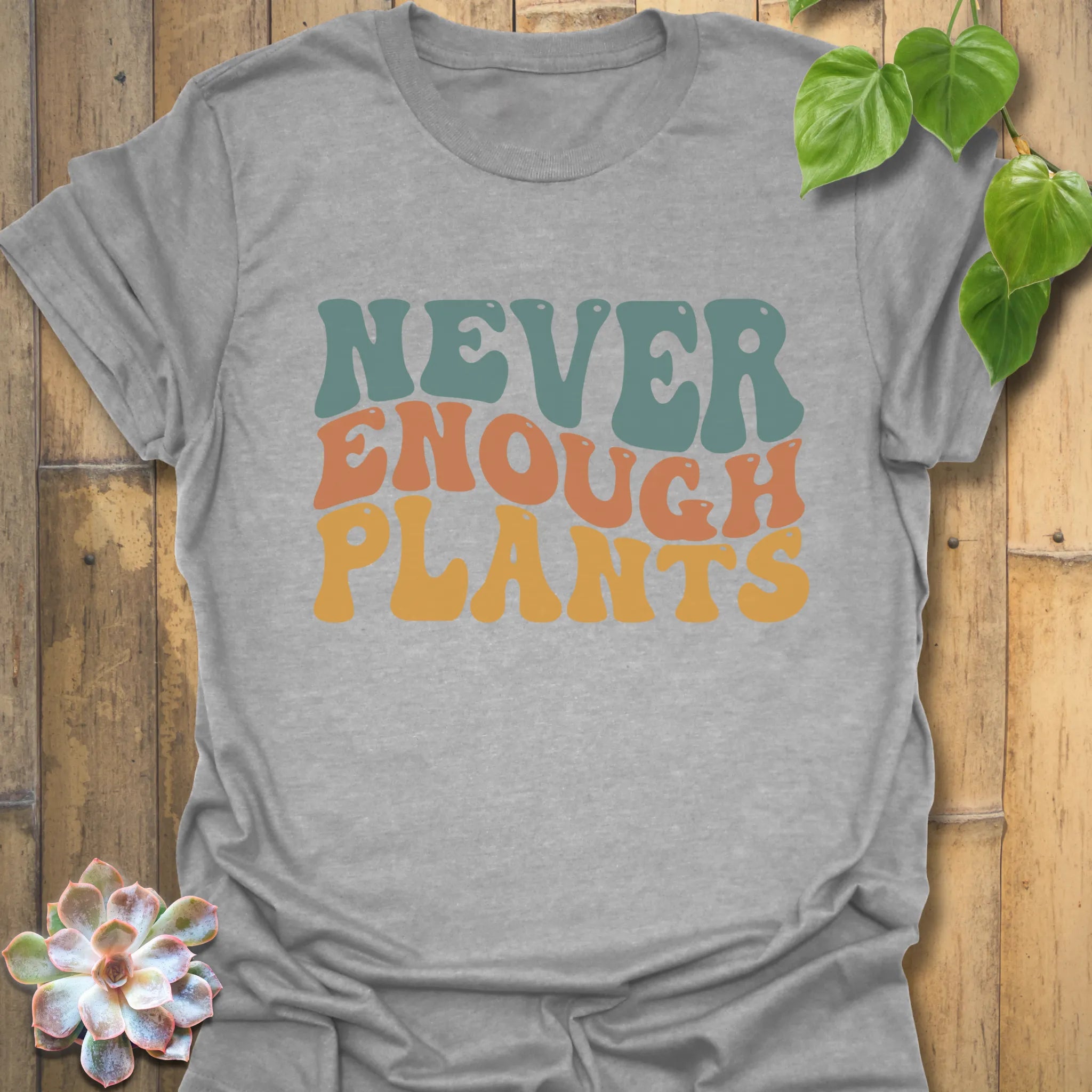 Sport grey t-shirt featuring the design Never Enough Plants in bold green lettering with leaf accent.