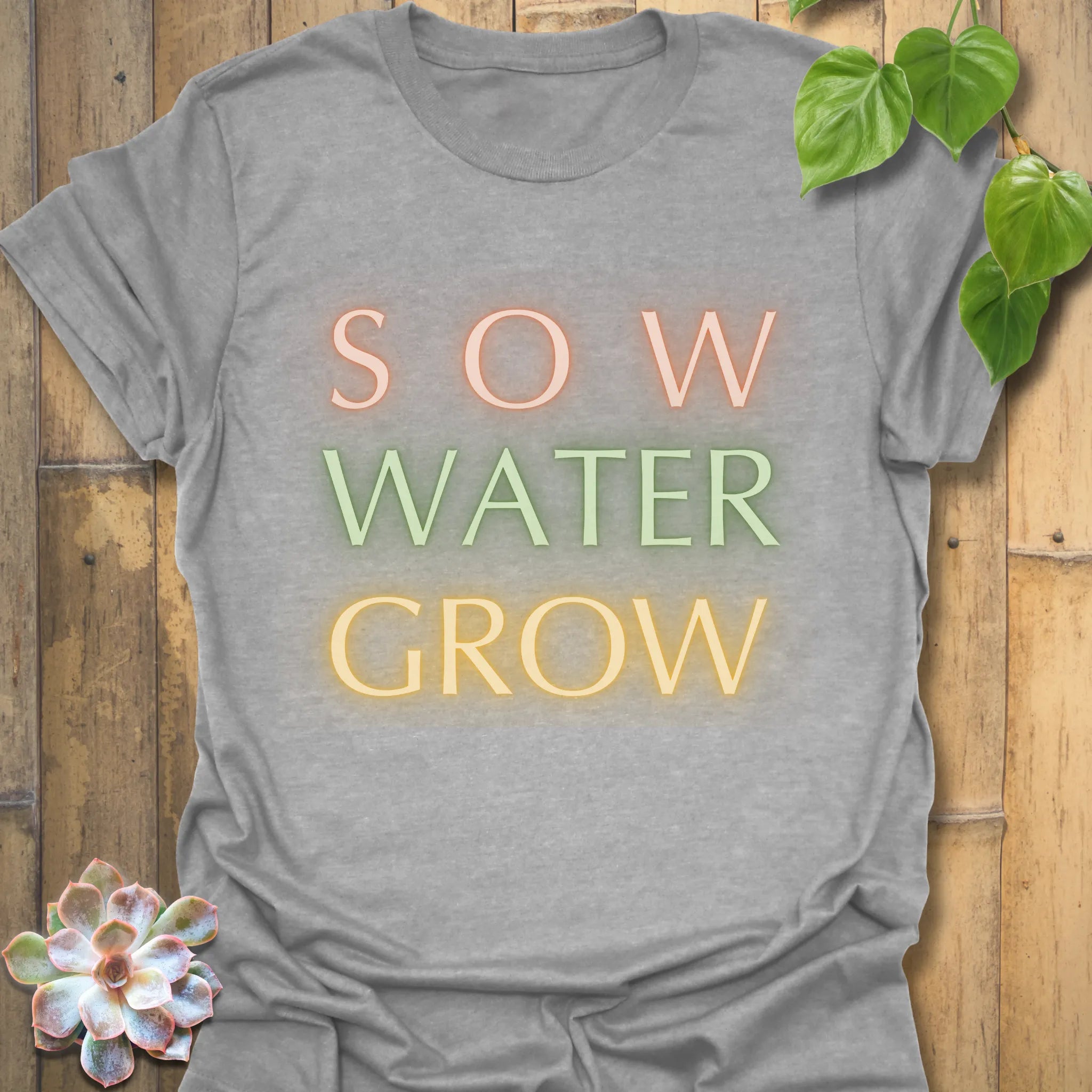 Sport grey t-shirt featuring the design Sow Water Grow printed with a minimalist gardening graphic.