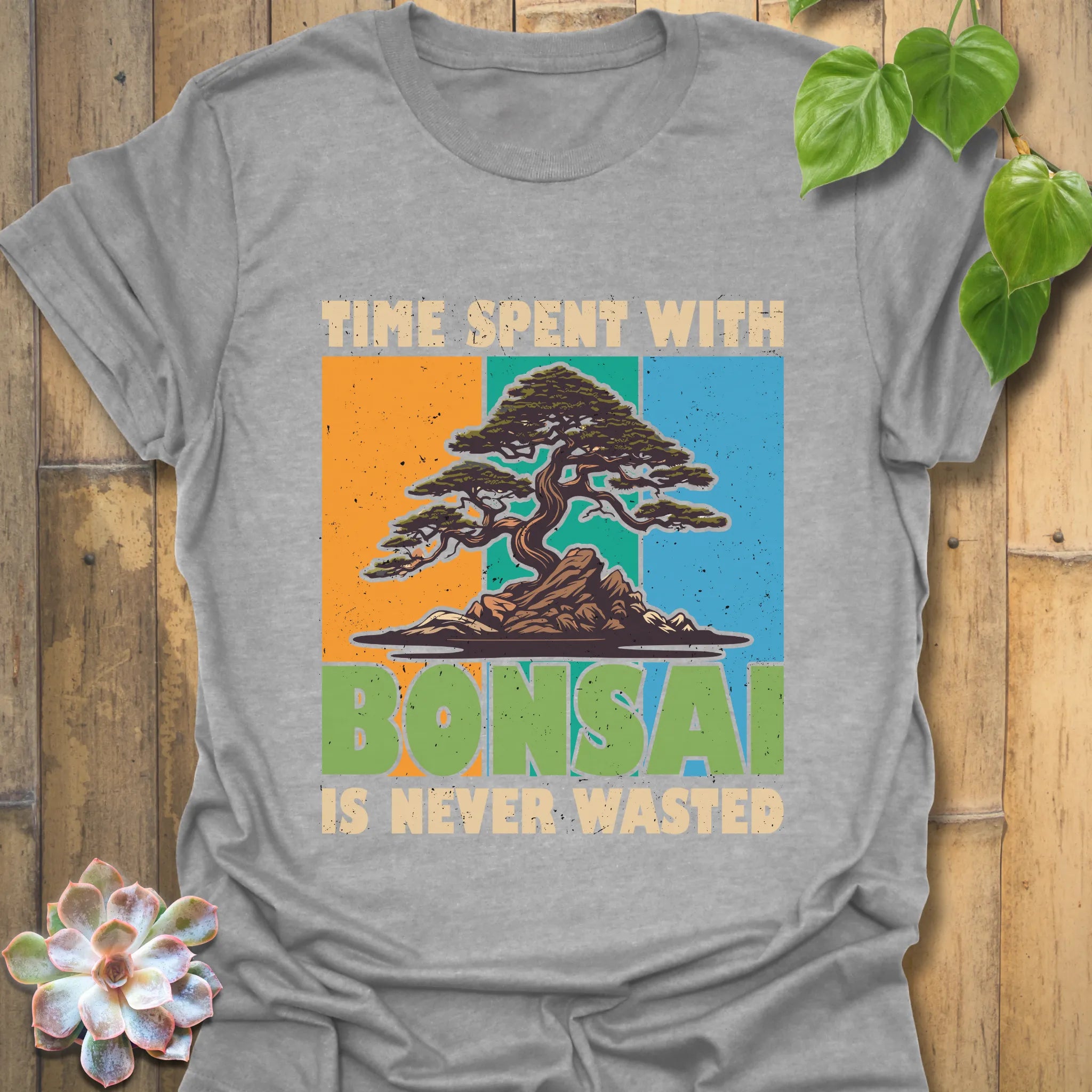 Sport grey t-shirt featuring the design “Time spent with bonsai is never wasted” with a bonsai plant print, comfortable wear for plant lovers.