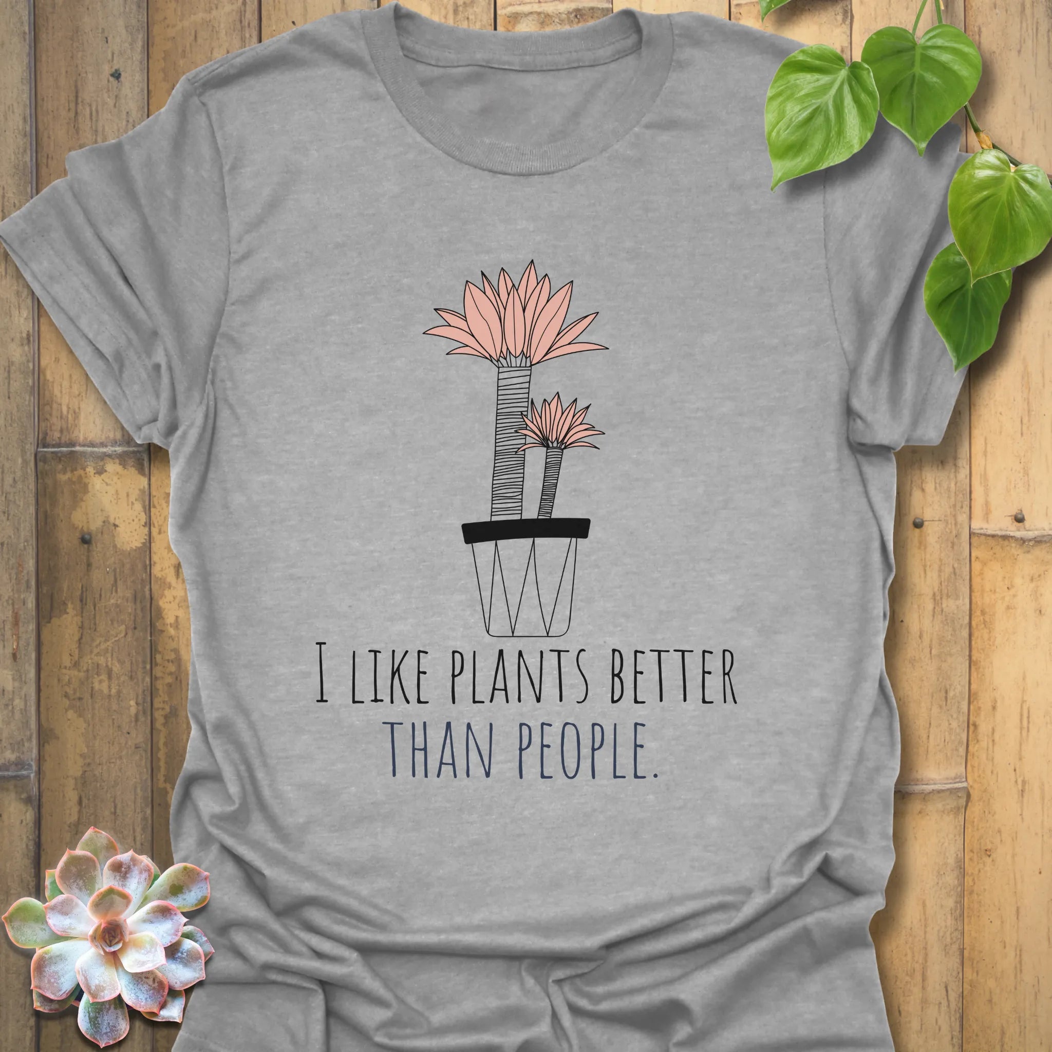 Sport grey t-shirt showing the words “I like plants better than people” and a flower in a pot print