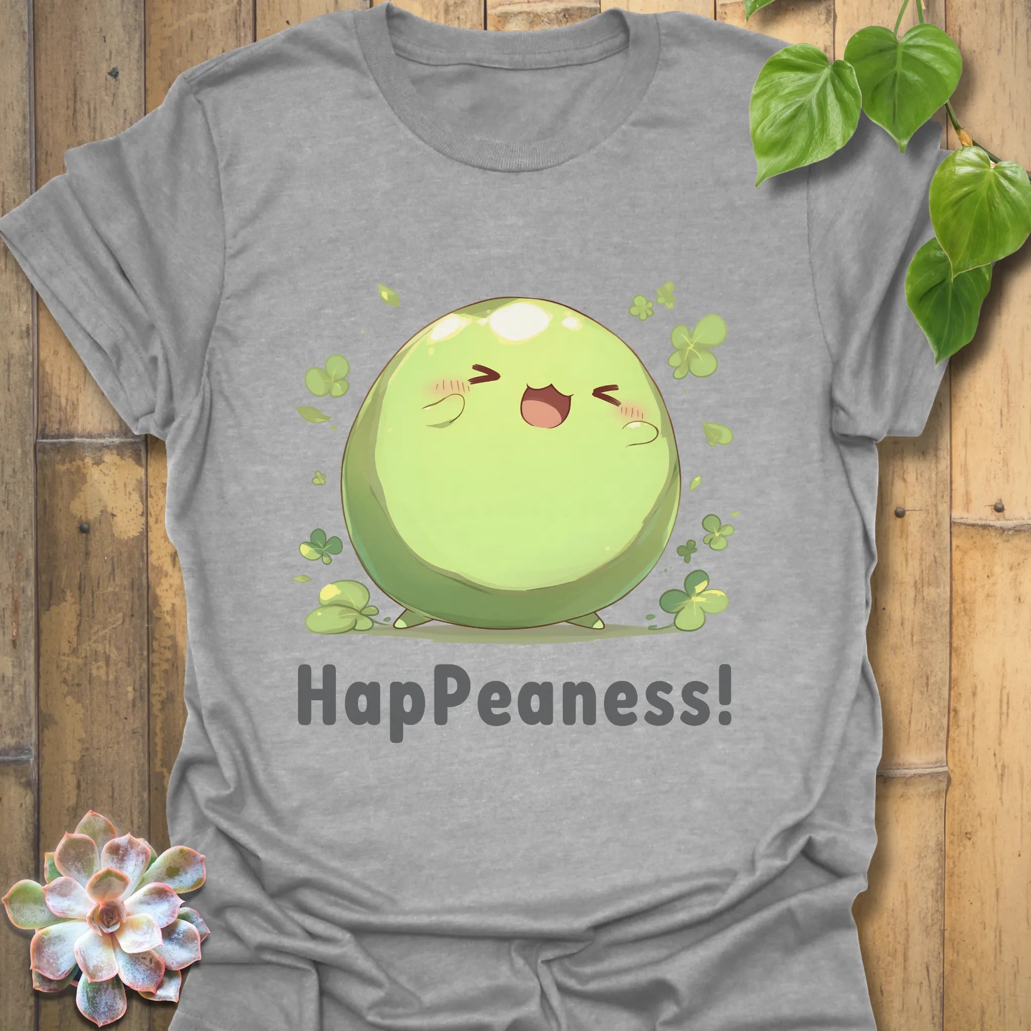 Sport grey t-shirt with a happy pea illustration surrounded by clovers and the text “HapPeaness!”
