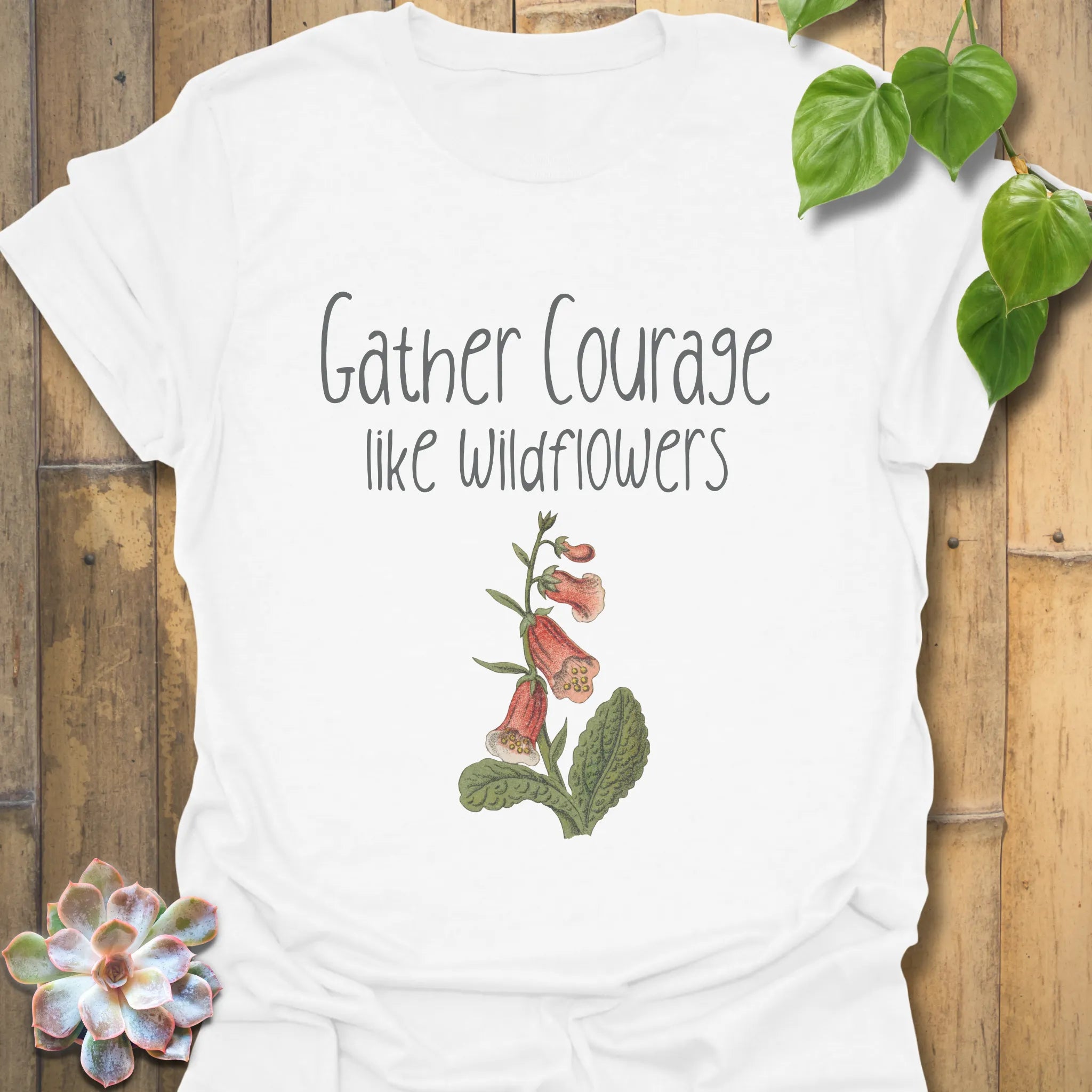 White botanical graphic t-shirt showing the quote ‘Gather courage like wildflowers’ paired with a simple floral print