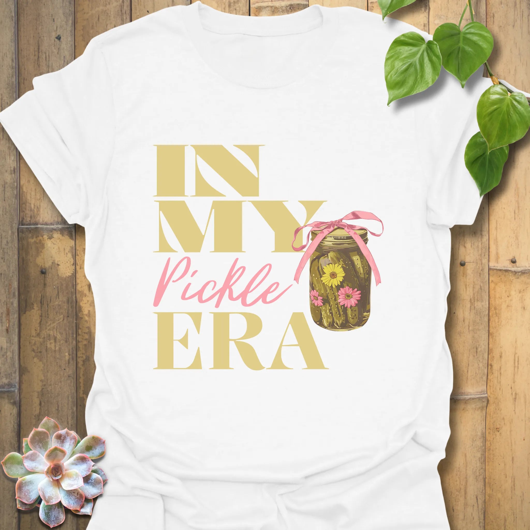 White t-shirt displaying the phrase “In My Pickle ERA” alongside a graphic of cucumbers inside a jar