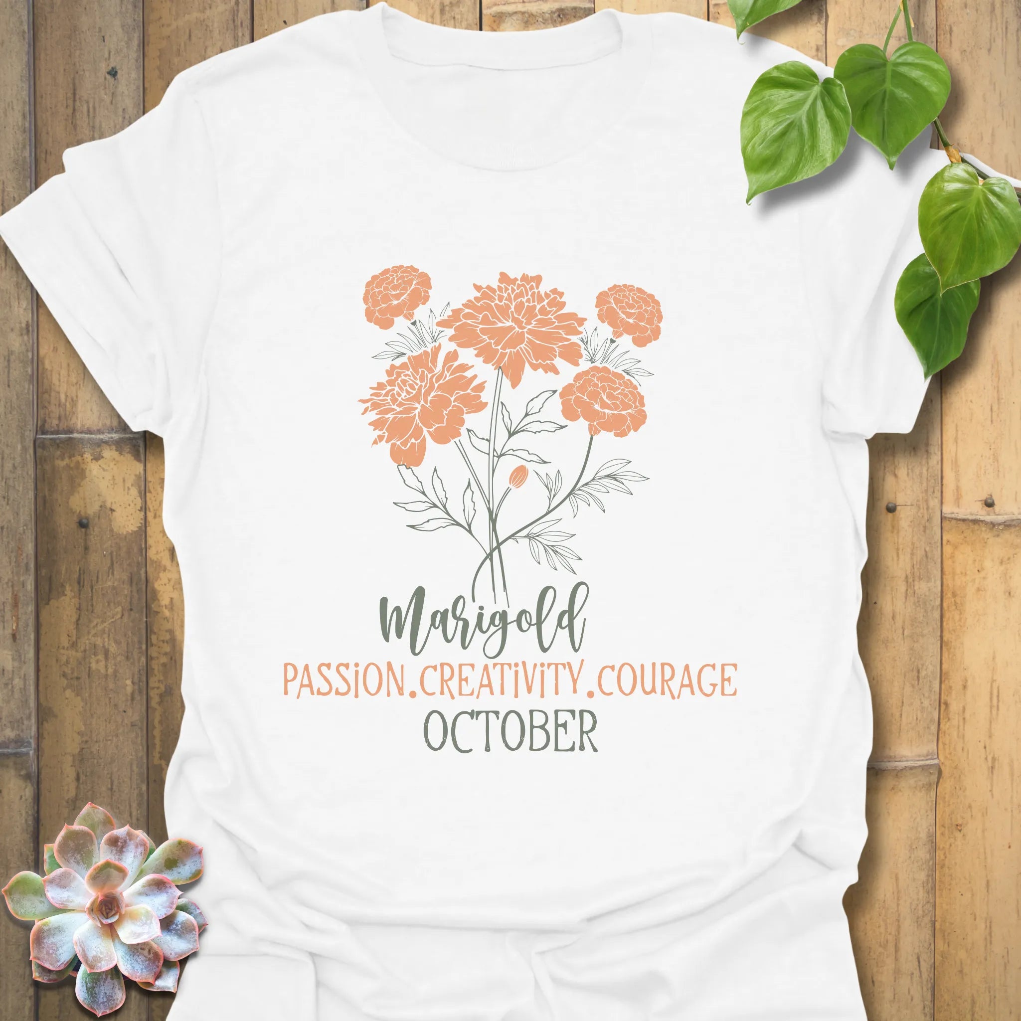 White t-shirt featuring the design October Marigold printed with a detailed marigold flower, perfect as a floral graphic tee.