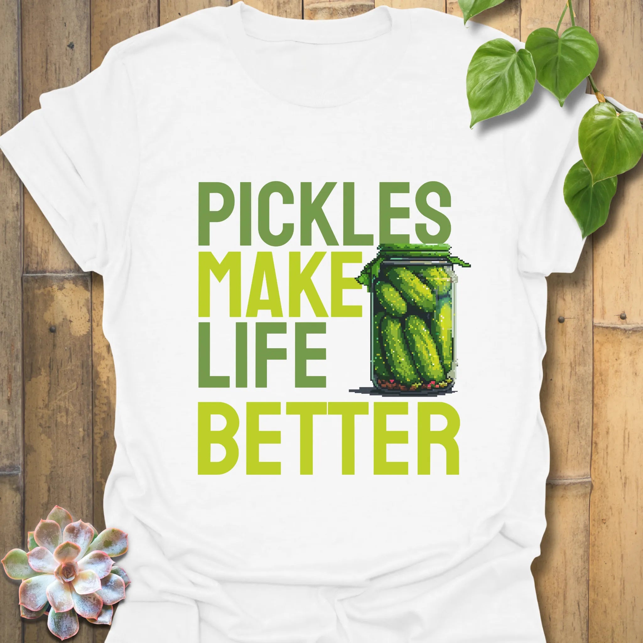 White t-shirt featuring the design “Pickles make life better” with cucumbers inside a glass jar