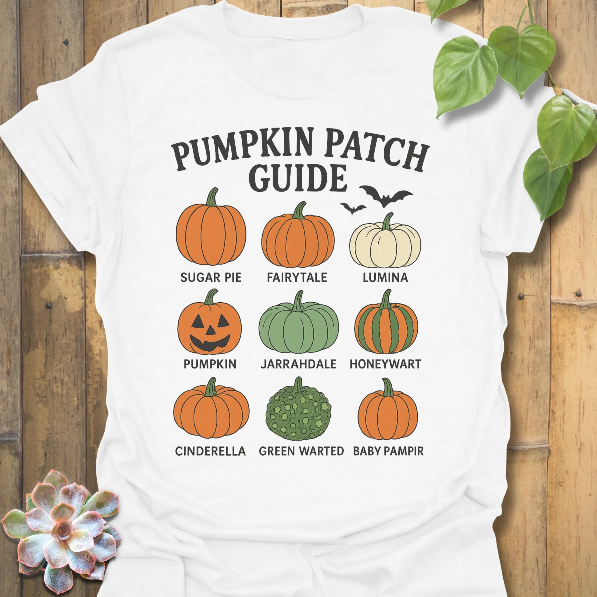 White t-shirt featuring the design Pumpkin Patch Guide printed in black letters, Halloween pumpkin tee.
