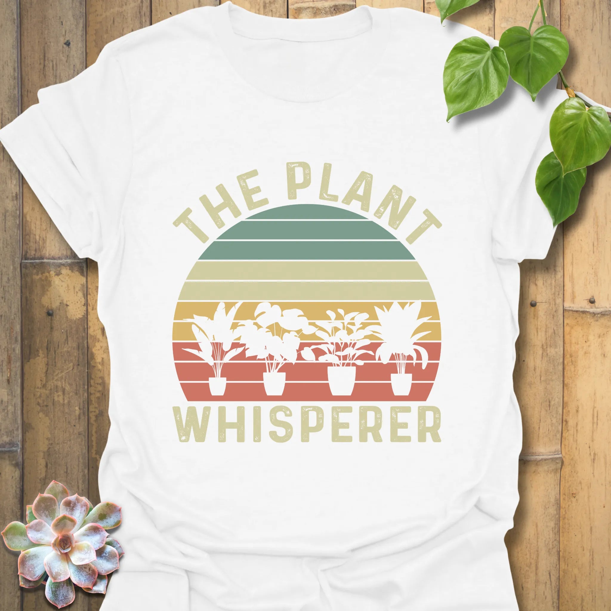 White t-shirt featuring the design The Plant Whisperer with a plant in a pot, perfect for plant lovers and gardening enthusiasts.