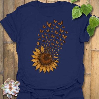 A bold navy tee featuring a radiant sunflower bursting into butterflies — the perfect mix of strength and serenity for nature lovers.