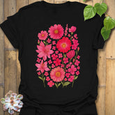 Black “Pink Blossom” T-shirt featuring bright pink floral blooms printed on soft Gildan 64000 cotton — bold and elegant for garden lovers.