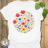 White “Circle of Flowers” T-shirt featuring a colourful circular floral design with wildflowers and butterflies, printed on soft Gildan 64000 cotton