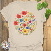 Natural off-white “Circle of Flowers” tee with colourful wildflower and butterfly print inside a circle, soft eco-toned Gildan 64000 cotton shirt.