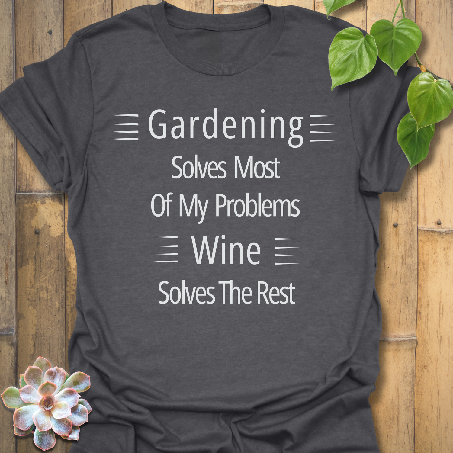 Gildan 64000 Dark Heather t-shirt featuring the quote ‘Gardening solves most of my problems, wine solves the rest’ in white lettering. Relaxed unisex style