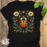 Black t-shirt featuring the design Blossom Beetle printed in nature-inspired floral beetle shirt.