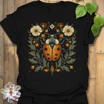Black t-shirt featuring the design Blossom Beetle printed in nature-inspired floral beetle shirt.