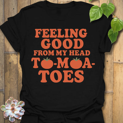Black t-shirt featuring the design Feeling Good printed in bold orange letters, feel-good graphic shirt.
