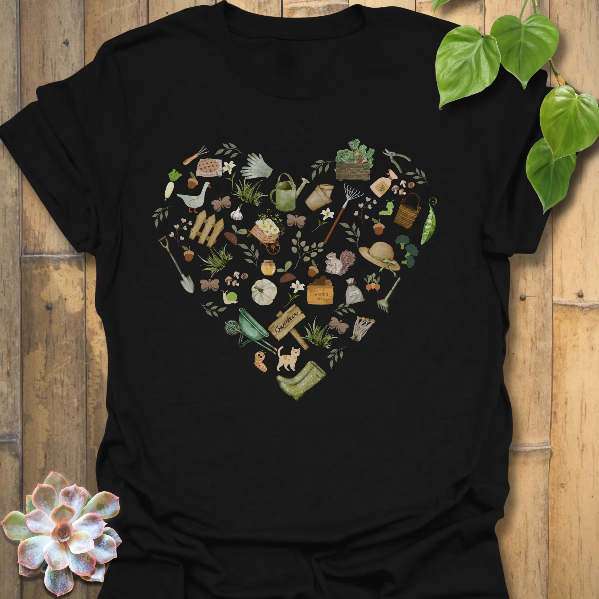 Black t-shirt featuring the design Gardening Loveheart printed in gardening graphic, perfect for plant lovers.