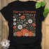 Black t-shirt featuring the design Harvest Dreams printed in bold orange letters, cosy harvest tee.