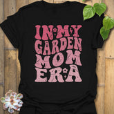 Black t-shirt featuring the design In My Garden Mom Era printed in bold letters, gardening shirt for moms.