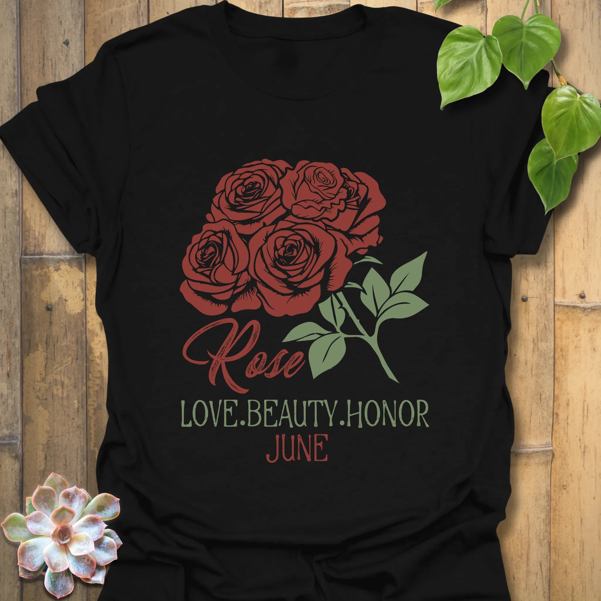Black t-shirt featuring the design June Rose with a striking rose flower print, a classic floral graphic shirt for versatile wear.
