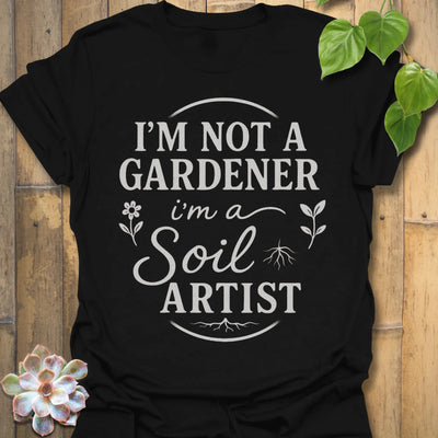 Black t-shirt featuring the design Soil Artist printed in bold letters, funny garden shirt.