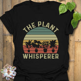 Black t-shirt featuring the design The Plant Whisperer with a plant in a pot printed, a trendy plant lover shirt for gardeners