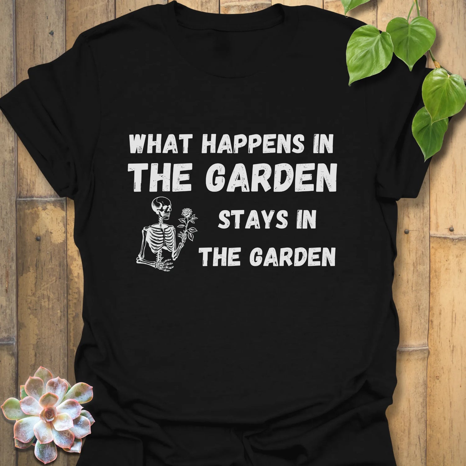 Black t-shirt featuring the design What Happens in the Garden Stays in the Garden, humorous gardening t-shirt.
