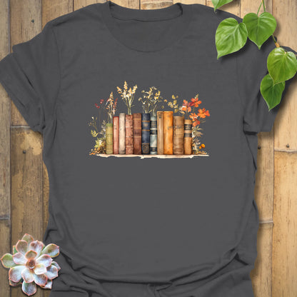 Charcoal “Wildflower Library” T-shirt showcasing a colourful stack of books with wildflowers — elegant design on soft Gildan 64000 cotton.