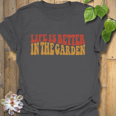 Charcoal t-shirt featuring the design Life is better in the garden printed in green floral lettering, casual gardening graphic tee.