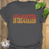 Charcoal t-shirt featuring the design Life is better in the garden printed in green floral lettering, casual gardening graphic tee.