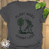 Charcoal t-shirt featuring the design Plant More Worry Less with a skeleton and plants character, modern eco-friendly graphic shirt.