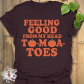 Dark Chocolate t-shirt featuring the design Feeling Good printed in bold orange letters, feel-good graphic shirt.