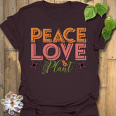 Dark Chocolate t-shirt featuring the design Peace Love Plant printed in bold letters, gardening lover shirt.