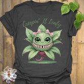 Dark Heather t-shirt featuring the design Creepin’ It Leafy printed in bold black letters, gardening graphic shirt.