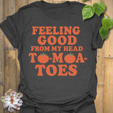 Dark Heather t-shirt featuring the design Feeling Good printed in bold orange letters, feel-good graphic shirt.