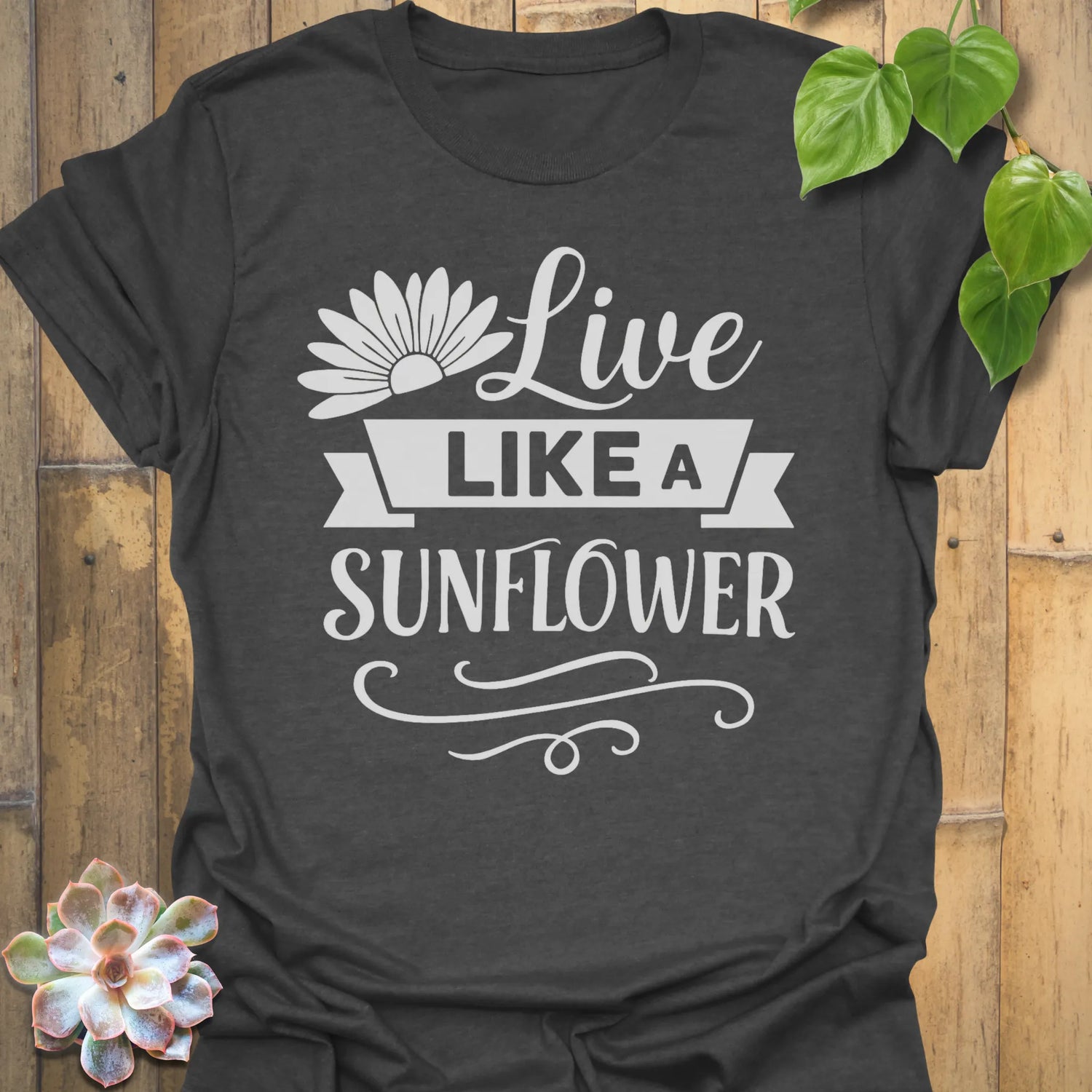 Dark Heather t-shirt featuring the design Live Like A Sunflower printed in bold black letters, sunflower lover shirt.