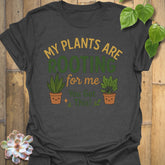 Dark Heather t-shirt featuring the design Plants Are Rooting printed in bold letters, gardening graphic tee.